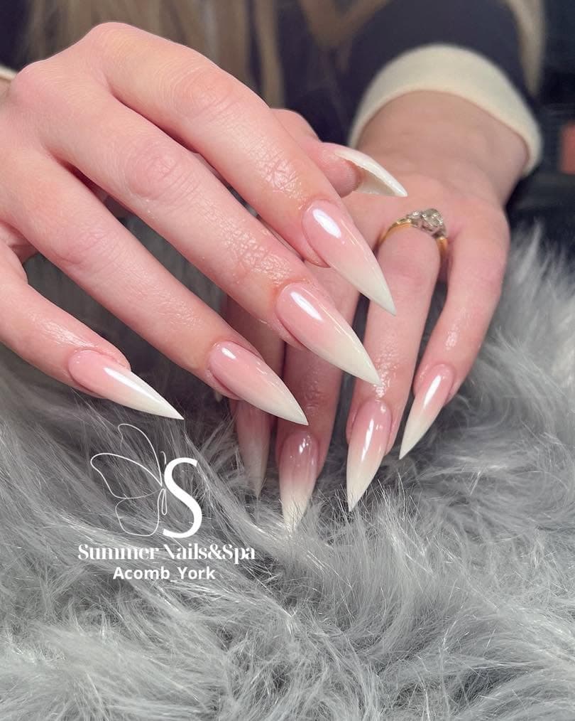 Long stiletto nails with a soft pink-to-white ombre