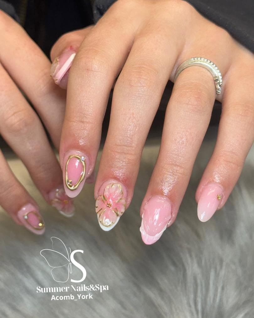 Pink almond nails with gold chrome and floral accent art