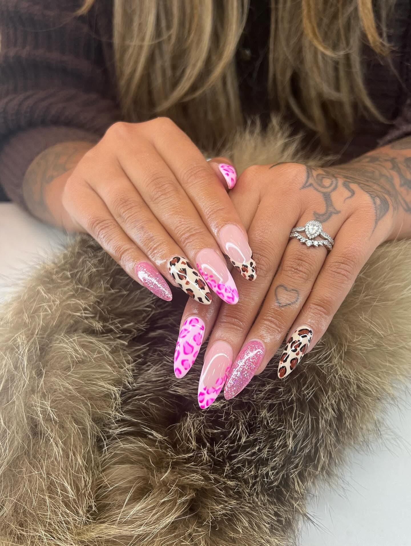 Pink stiletto nails with leopard print and heart details