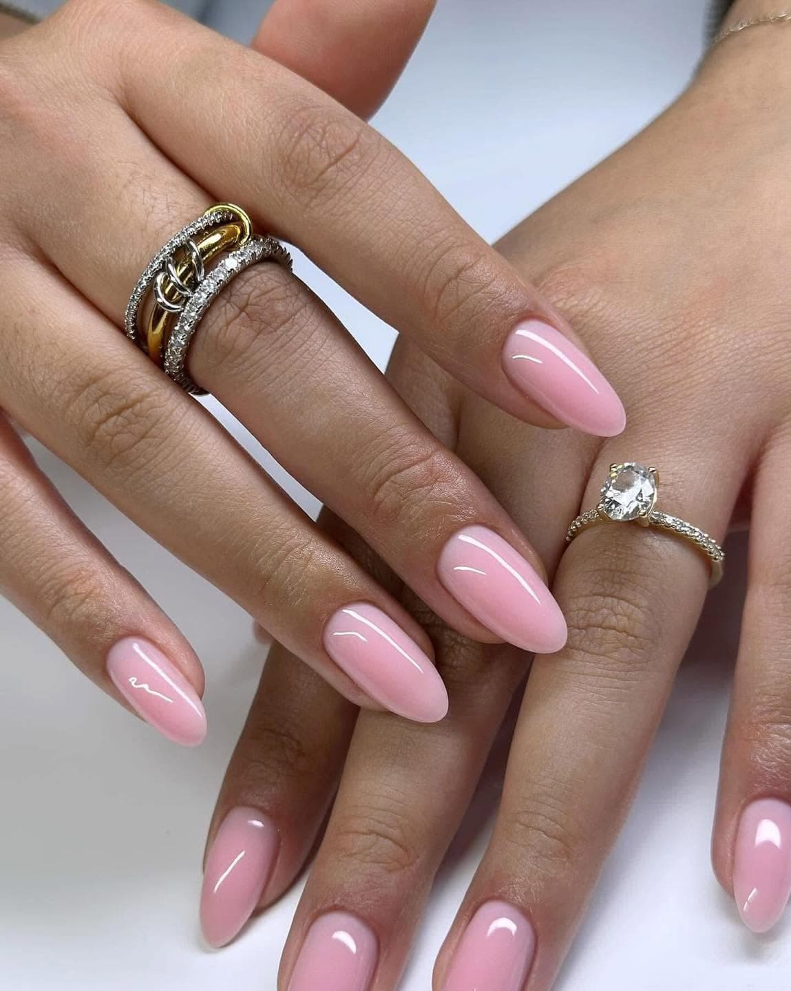 Glossy baby-pink almond gel nails